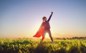 Girl playing superhero in a field is a vegan champion